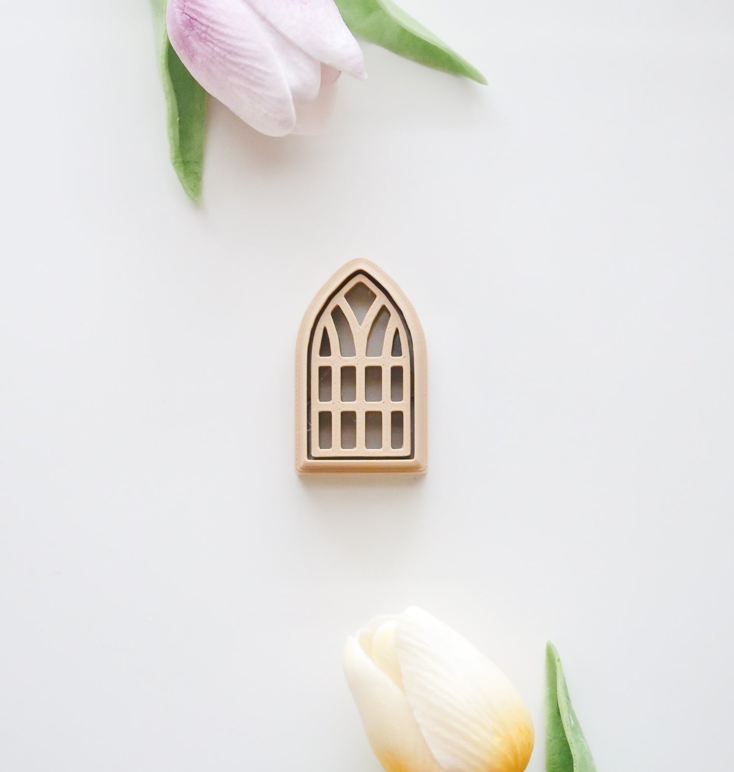The Window Polymer Clay Cutter Set by Hello Cutters features a decorative arched window frame design with pink and yellow tulip accents—perfect for 3D printing or as inspiration for polymer clay projects.