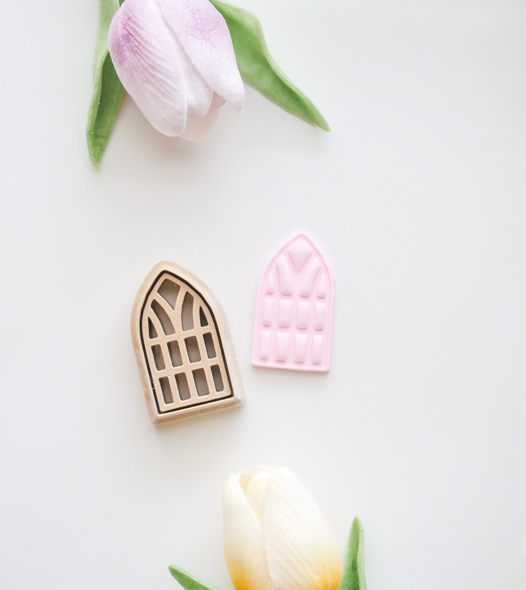 The Window Polymer Clay Cutter Set by Hello Cutters includes one beige and one pink window-shaped cutter, displayed with two artificial tulips on a white background—ideal for FDM 3D printer fans using STL files.