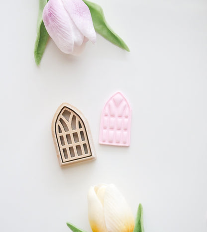 The Window Polymer Clay Cutter Set by Hello Cutters includes one beige and one pink window-shaped cutter, displayed with two artificial tulips on a white background—ideal for FDM 3D printer fans using STL files.